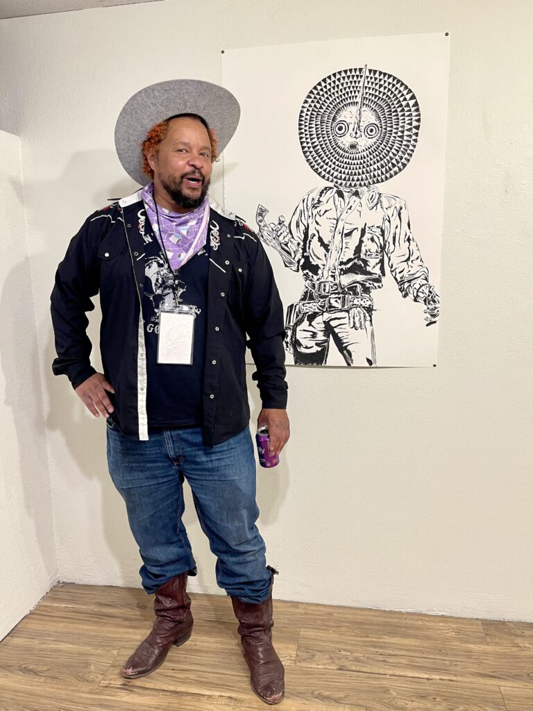 Artist Brent Holmes in front of his pen and ink drawing and exhibition, Jones Ranch Egypt, at Available Space Art Projects (ASAP)