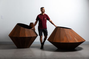 Artist Luis Varela-Rico and his steel sculptures: Large Corten Vessel 1 and 2. Image by Krystal Ramirez