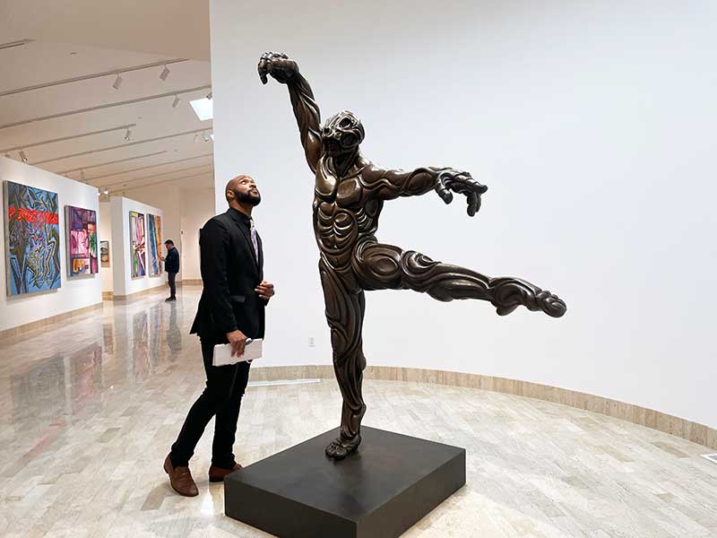 A Rita Deanin Abbey Art Museum guest with Abbey's sculpture, Bangarra.